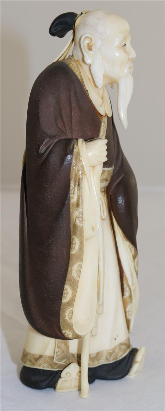 A Japanese ivory figure of a Chinese sage, Taisho period, 18.5cm, loss to staff